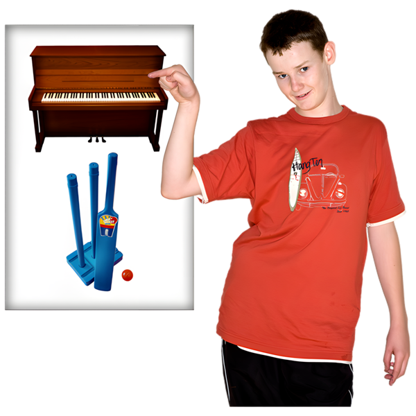A boy in a red t-shirt pointing to a piano and cricket set.