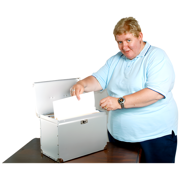Person placing or removing a white envelope from a box on a table.