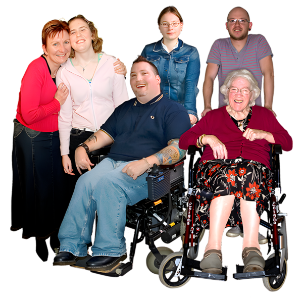 A diverse group of six people, including two in wheelchairs, smiling at the camera.