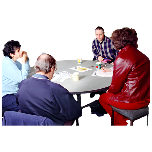 Four people sitting around a round table, talking.