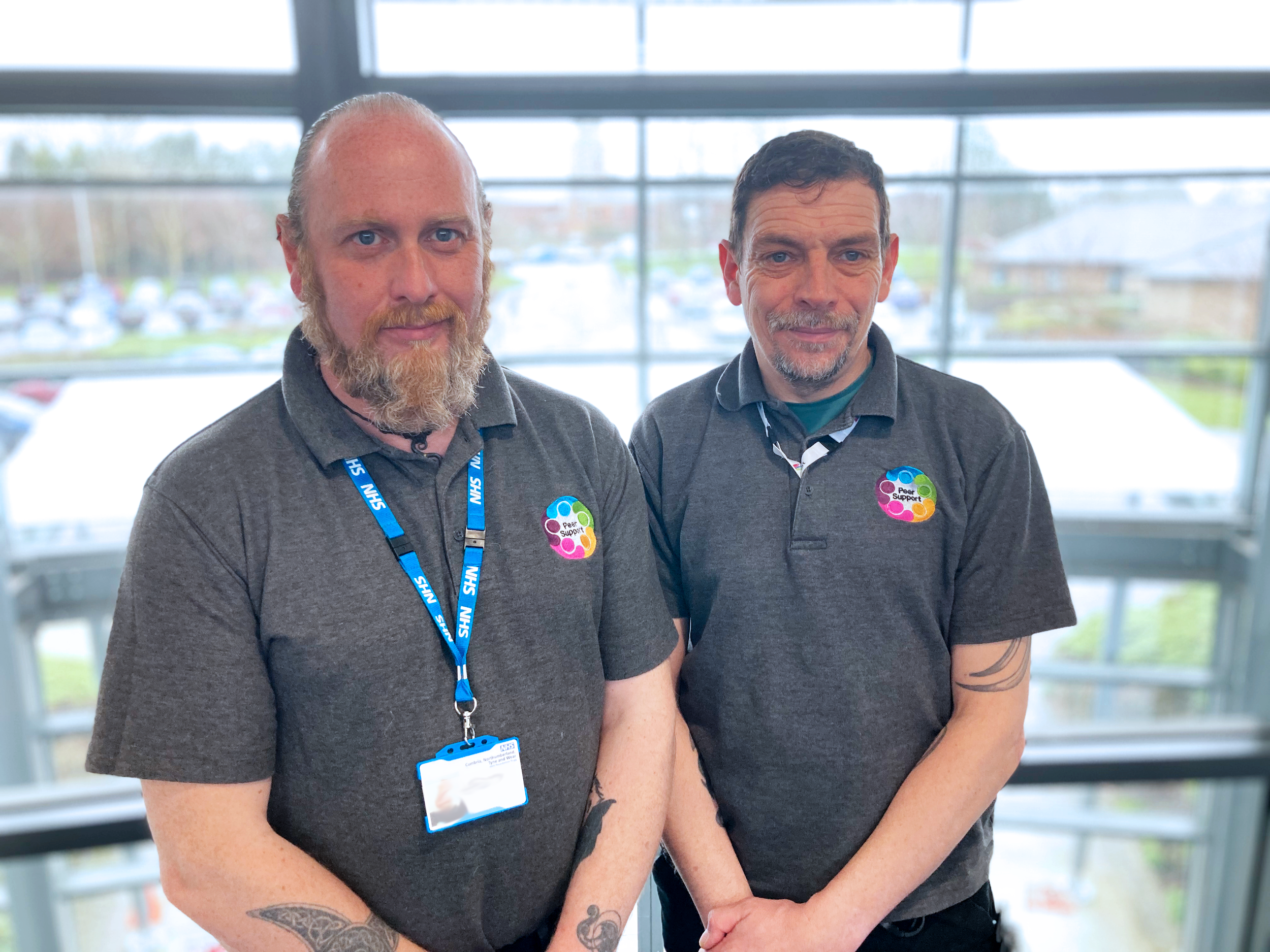 Two Peer Supporters, smiling to camera