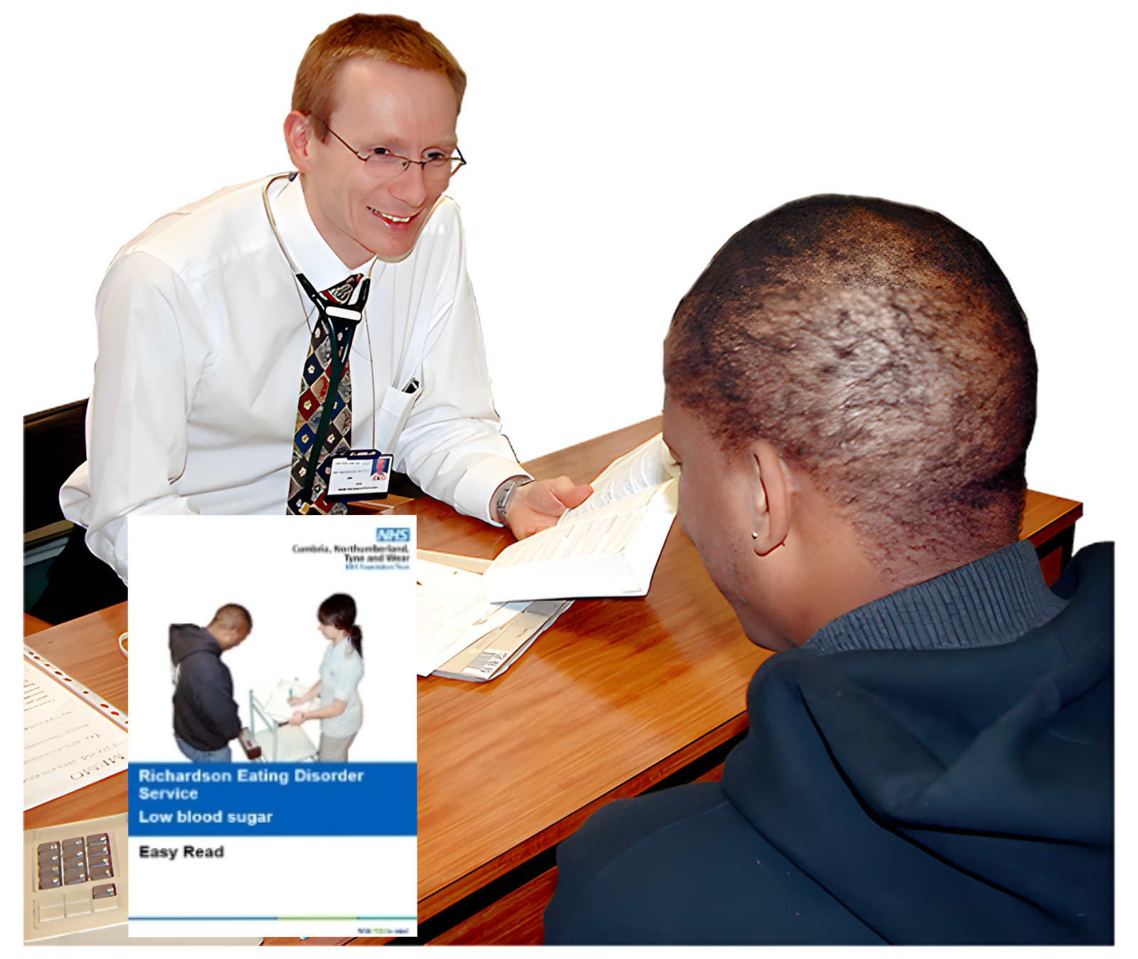 Man in glasses and white shirt holding paper, talking to another man in a dark sweatshirt across a desk.