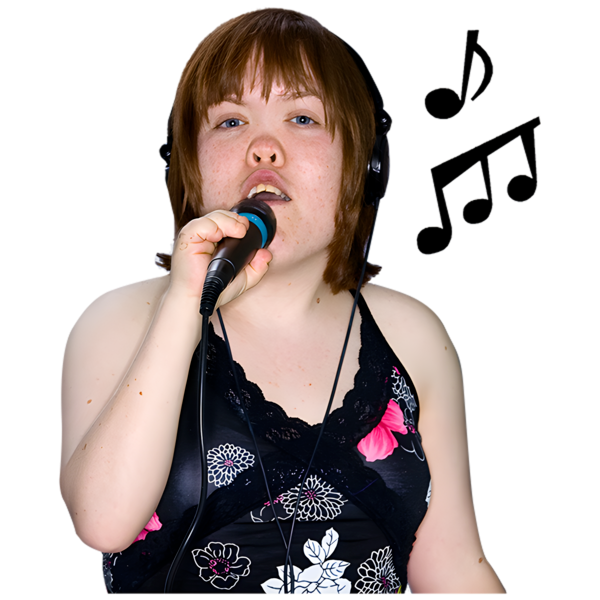 Person singing into a microphone with headphones on, wearing a black floral top.