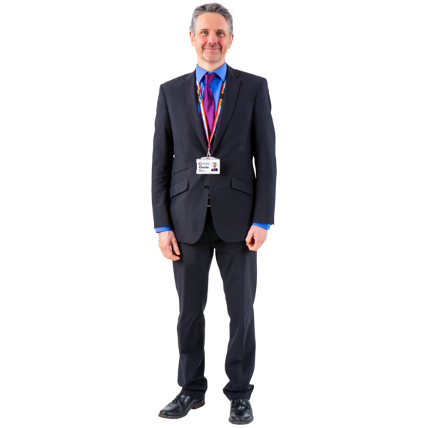 A man wearing a suit and an ID badge around his neck