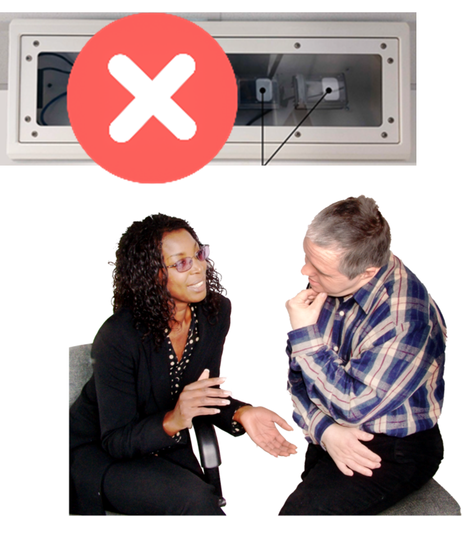 A picture of the Oxevision camera with a red cross through it. There are two people discussing next to it.