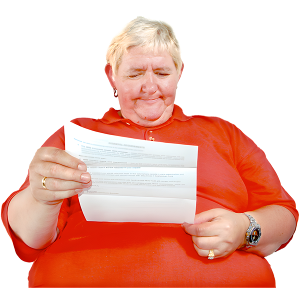 Person in a red polo shirt reading a piece of paper.