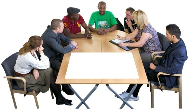 Lots of people sitting around a table having a meeting