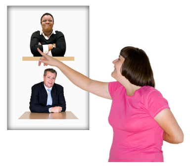 A woman pointing to a poster with a picture of a woman and a man