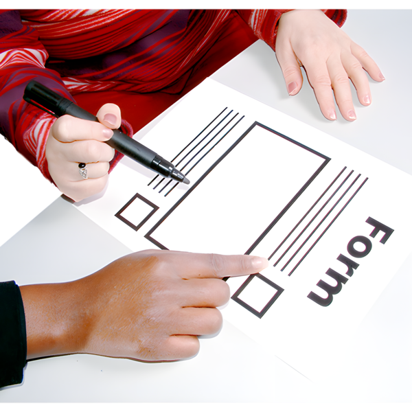 Two people work together on filling out a form with a black marker.