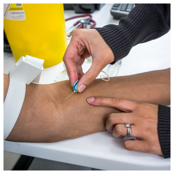 Close up of a man having blood taken from his arm