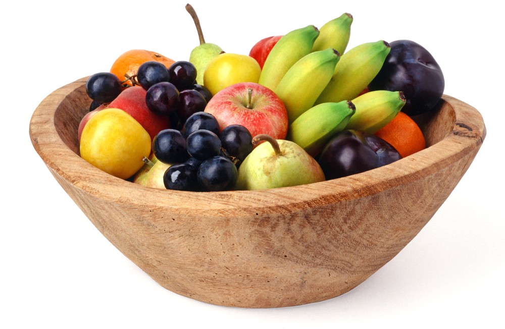 wooden bowl containing a variety of fruit