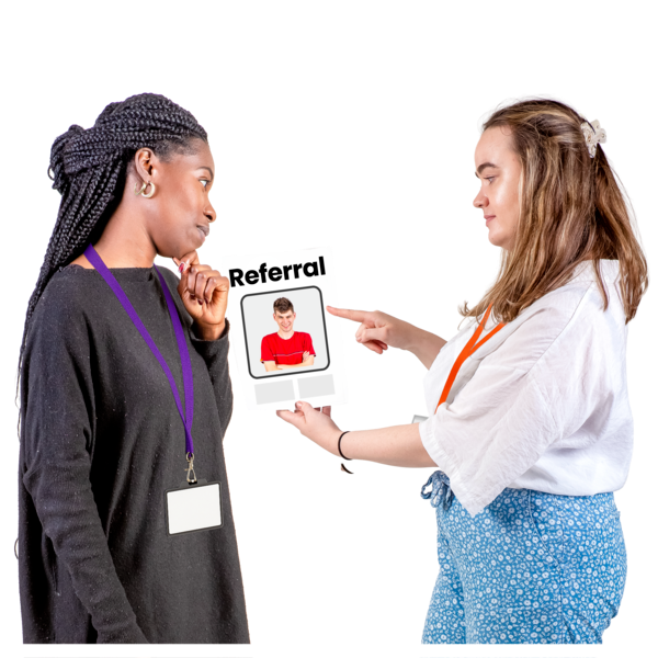 Two people looking at a referral form