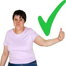 A woman is holding up her thumb. There is a big green tick next to her.