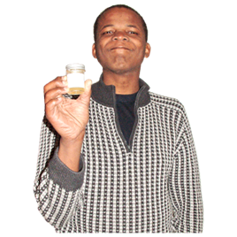 A person holding a urine sample in a small container