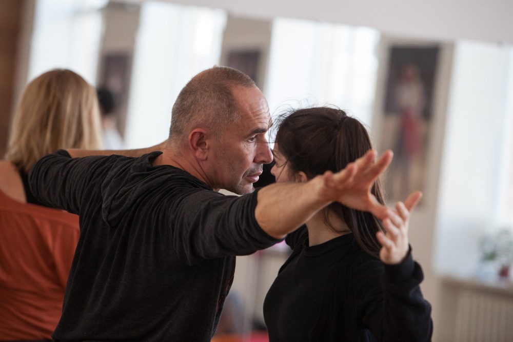 Man and woman with their arms stretched out to the side