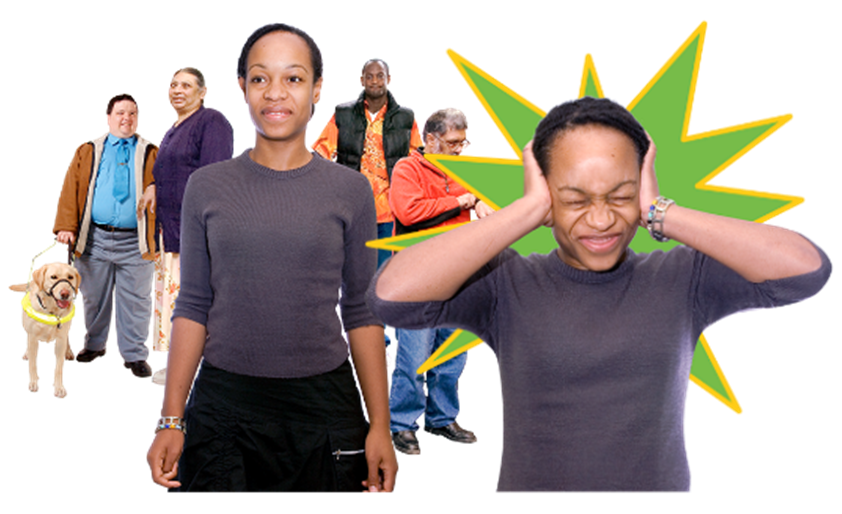 A woman is in a room with lots of other people and covering her ears to keep out the noise