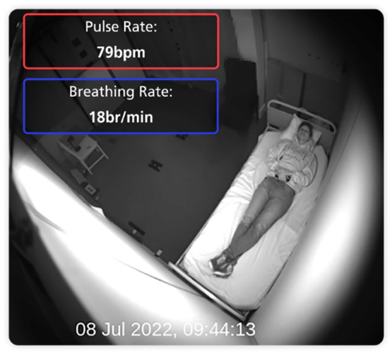 A view of the bedroom taken by the camera from the ceiling and looking down to the bed. It shows the pulse rate and breathing rate of the person in the room.