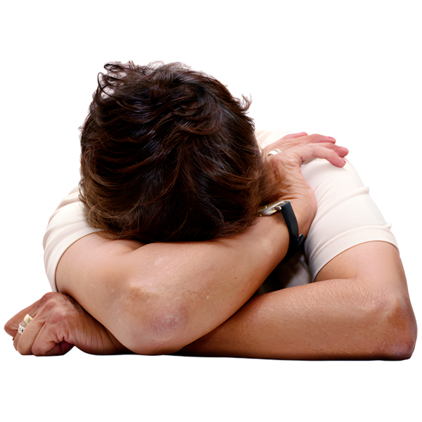 Person resting head on crossed arms