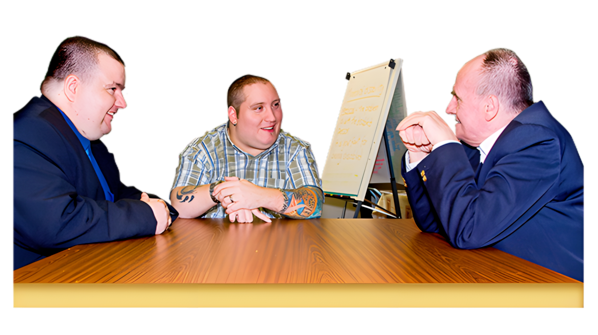 3 men talking while sitting around a table