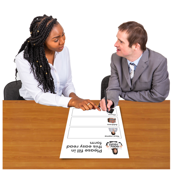 A woman helping a man fill in a form