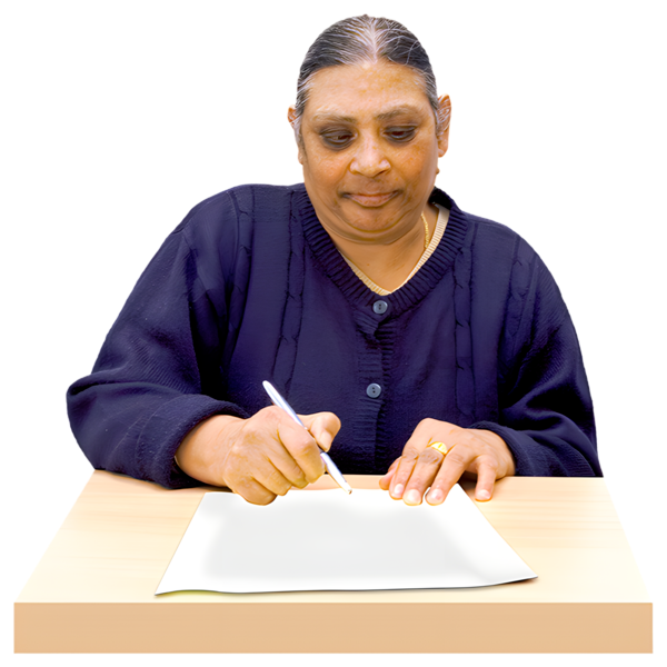 A person sitting at a desk filling in a form