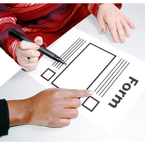 A person pointing to a form, and another person holding a pen ready to sign