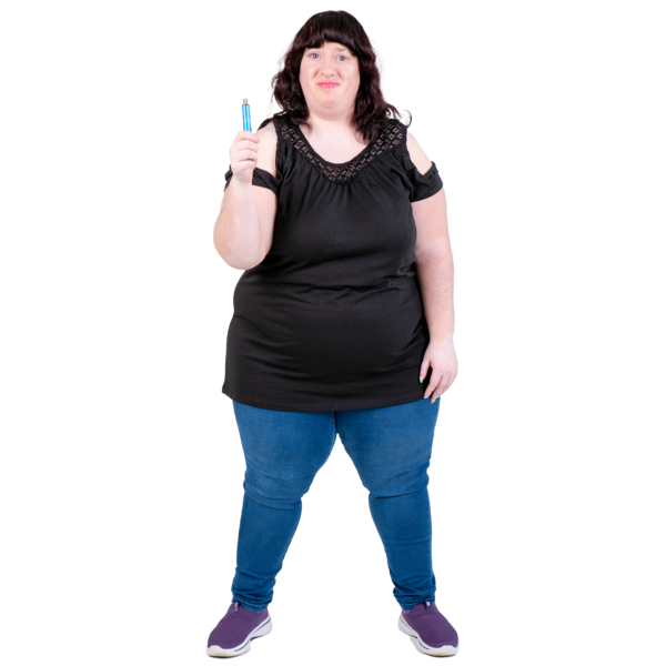 Woman in a black top and blue jeans holding a small blue object.