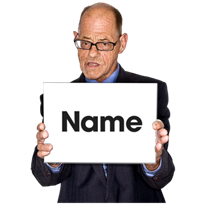 An older man holding up a card with Name written on it.