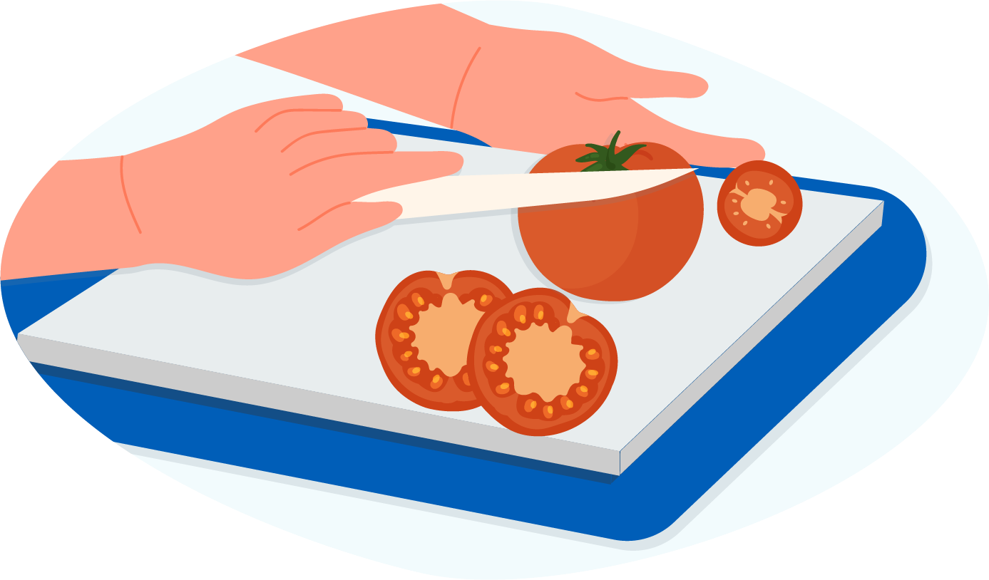 Person chopping a tomato on a tray with a rubber base