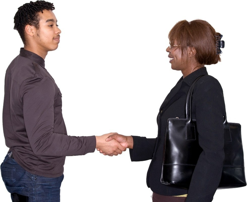 A man and a woman shaking hands and smiling