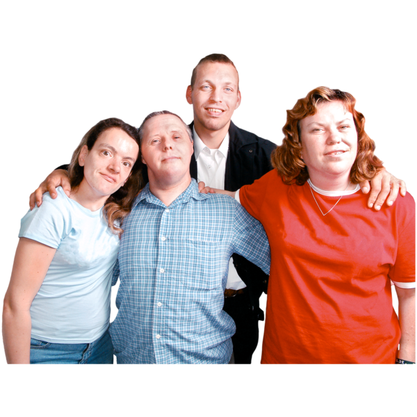 A group of four people standing closely together, smiling.