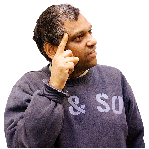 Man in a dark sweatshirt with '& SO' printed on it, resting his index finger on his temple in a thoughtful pose.