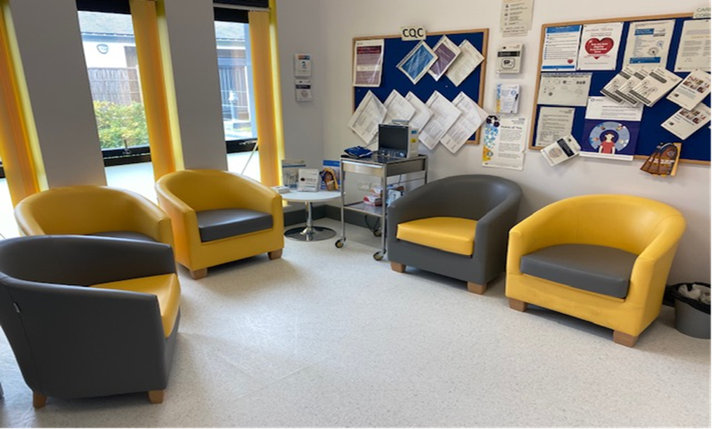 Waiting area with 5 armchairs and notice boards