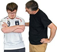 A man supporting a boy expressing his feelings