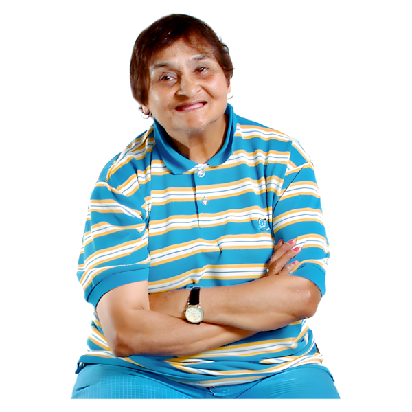 An elderly person smiling, wearing a blue and yellow striped shirt, with arms crossed.