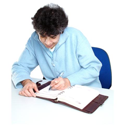 A person writing into a notebook