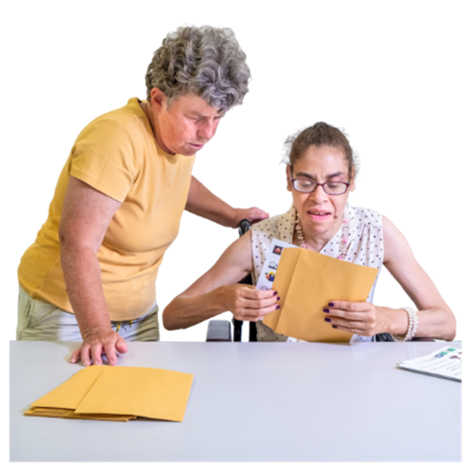 Somebody opening an envelope with a report inside. Next to them is a carer supporting them. 