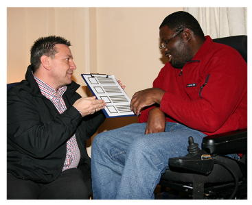 A man explaining information in a document to another man