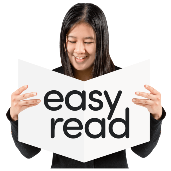 A person holding a booklet with easy read written across the front of it